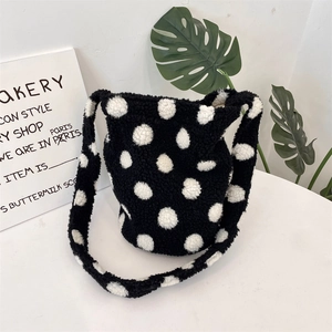 Detailed texture of white polka dot plush bucket bag with soft faux fur finish