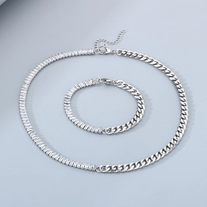 Detail of silver stainless steel Cuban link necklace and bracelet set with zircon stones