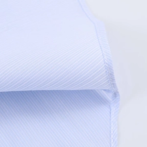 Close-up of blue and white plaid shirt fabric showing twill texture and seam stitching