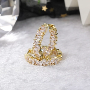 Macro shot of gold hoop earrings featuring a single row of pear-cut AAA cubic zirconia