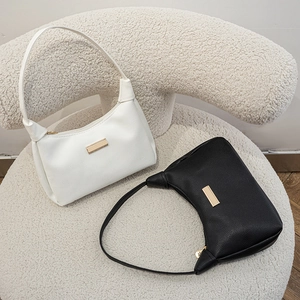 Versatile pebble grain leather hobo shoulder bags in black and white with gold metal accents