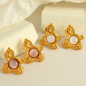 French vintage metal flower earrings with pink and white gemstones on geometric display