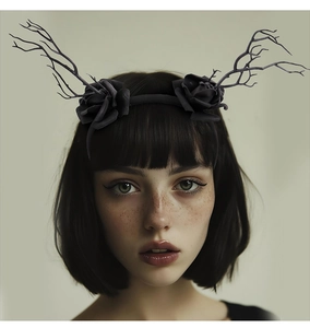 Gothic Halloween headband with black roses and branch-style antlers on a female model