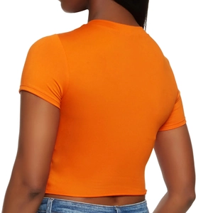 Rear view of tight orange short sleeve crop top showing premium knit texture and fit