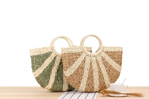 Detail of woven straw handbags with round handles in bicolor summer vacation style