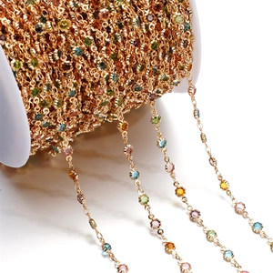Detailed macro view of multi-colored gemstones set in a golden copper DIY jewelry chain