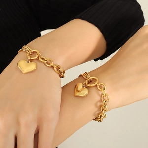 18K gold plated Cuban heart bracelet with multi-layer chain design on model's wrist