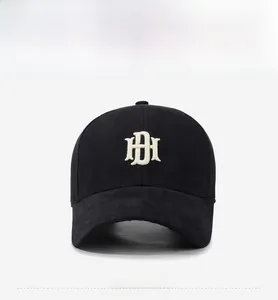 Detail of 3D embroidered DH logo on black baseball cap with curved brim and cotton fabric