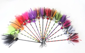 Detail of colorful Halloween witch brooms with mesh brushes and decorative ribbons