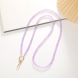 Purple 8mm crystal beaded phone crossbody strap with gold metal clasps on white background