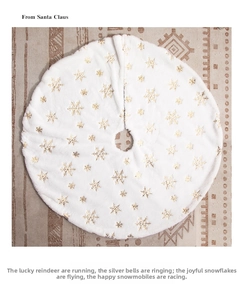Detail of white plush Christmas tree skirt with golden snowflake patterns for holiday decor