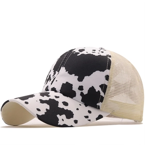Crisscross ponytail baseball cap with cow print pattern and breathable mesh back