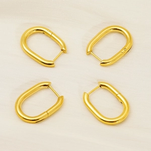 Polished 18k gold plated stainless steel U-shaped hoop earrings set on fabric background