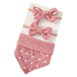 3-piece baby set with dusty rose muslin bib and bow headbands on display card