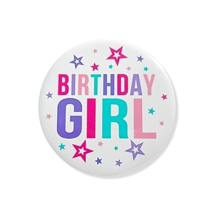 Detailed view of round white Birthday Girl badge with colorful star patterns and text