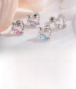 Detailed view of silver titanium steel heart stud earrings with colorful zircon drops