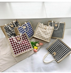 Detail of canvas tote bags with houndstooth and zebra patterns and wooden button closures