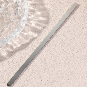 Detail showing sleek matte silver stainless steel cuff bracelet with smooth polished edges