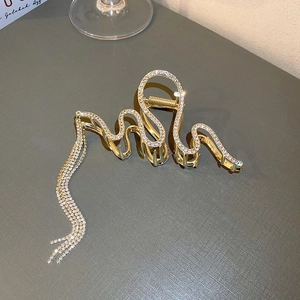 Golden snake hair claw clip with rhinestones and long tassel fringe for elegant styling