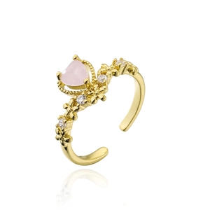 Golden crown open ring with pink heart stone and white zircon accents on white background