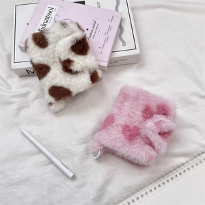 Detailed view of plush heart and cow print mini card binders with soft fur texture
