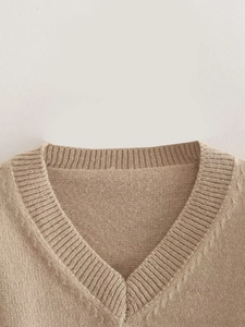 Close-up of a French style V-neck brown knit sweater featuring ribbed collar details