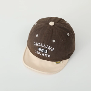 Detailed macro view of cotton baby baseball cap with embroidered Catalina 1983 text