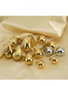 Detailed display of chunky teardrop and hammered earrings in gold and silver finishes