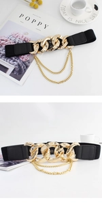 Detail view of fashion wide elastic belt with large gold chain buckle and layered chains