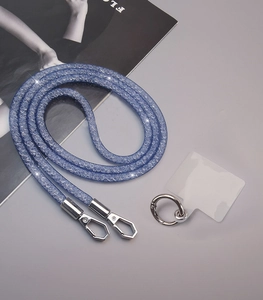 Close-up of blue glitter crossbody phone strap with silver spring buckles and patch