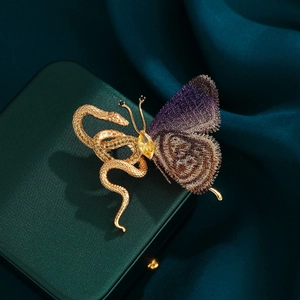 Exotic golden snake and purple butterfly brooch on deep teal silk background