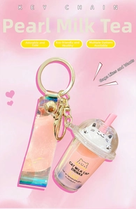Detail of creative cat milk tea cup keychain with a pink laser holographic wrist strap