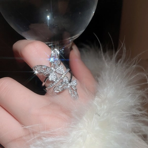 Close-up of a layered silver butterfly ring with cubic zirconia stones on a hand
