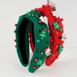 Close-up of knit Christmas headbands with rhinestone snowman and tree decorations