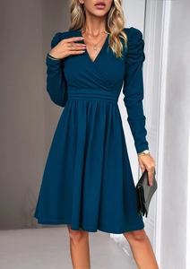 Detailed view of dark blue long-sleeved V-neck dress with cinched waist and A-line silhouette