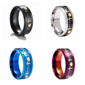 Macro shot of 8mm titanium steel rings with carbon fiber inlay and gold heartbeat pattern