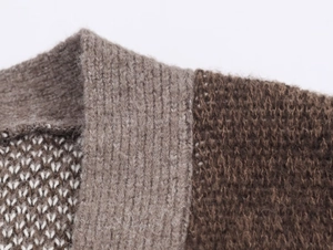 Detail of coffee and beige jacquard knit sweater with ribbed texture and intricate weave
