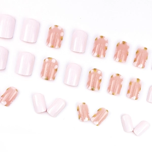 Short press-on nails set with pink floral designs, gold glitter, and glossy finish