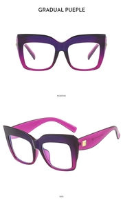 Detail of purple gradient cat-eye glasses frame with golden metal hinge accents