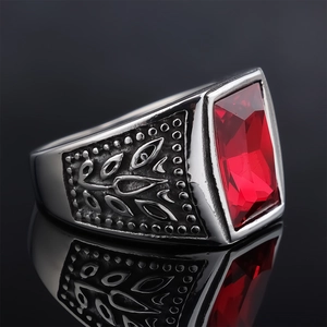 Close-up of vintage silver ring with large red rectangular gem and leaf embossing