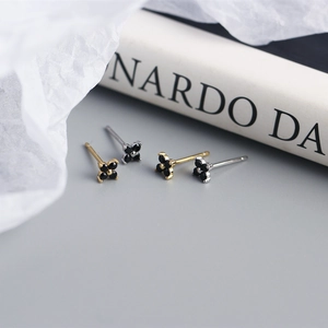 Detailed macro view of S925 silver four-leaf clover stud earrings with black stones