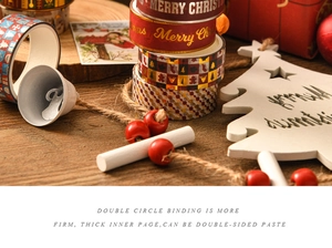 Detail of Christmas washi tape with gold foil patterns on warm wooden background