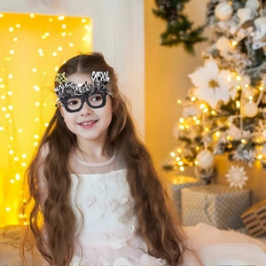 Detail of 2024 Happy New Year party glasses with silver tinsel and yellow star decor
