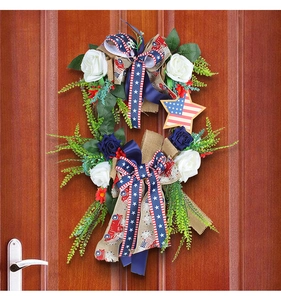 Detail of USA Independence Day wreath featuring blue roses and stars and stripes ribbon