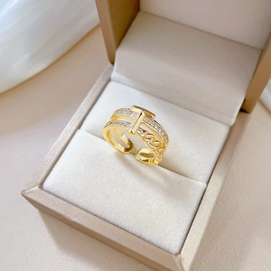 Detailed view of adjustable gold-plated ring with rectangular and round cubic zirconia