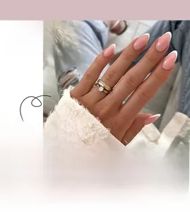 Detail of long almond press-on nails with nude pink base and classic white French tips