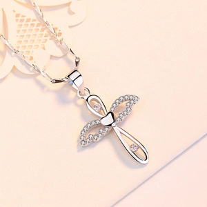 S999 sterling silver cross necklace featuring winged heart pendant with clear crystals