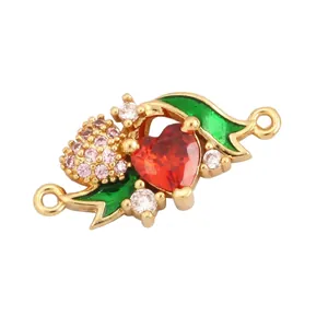 Detail of 19mm gold-plated copper connector with red heart stone and enamel leaves