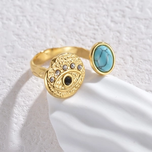 Adjustable gold evil eye open ring with turquoise and sparkling stones on wave stand