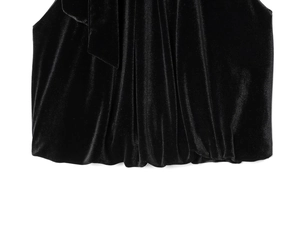 Detailed close-up of premium black velvet fabric texture with elegant pleated hem details